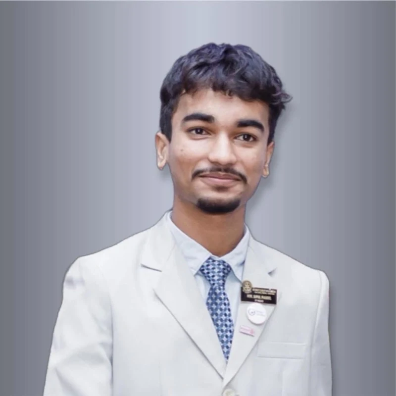Portrait of Dipul Poudel wearing a light suit and patterned tie